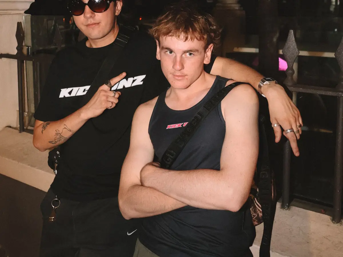 Two friends outside a nightclub at night