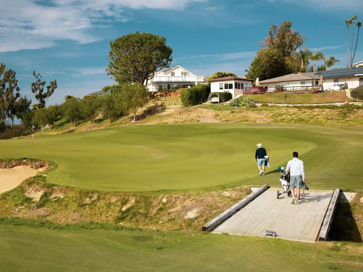 Golfers walking a green at a country club