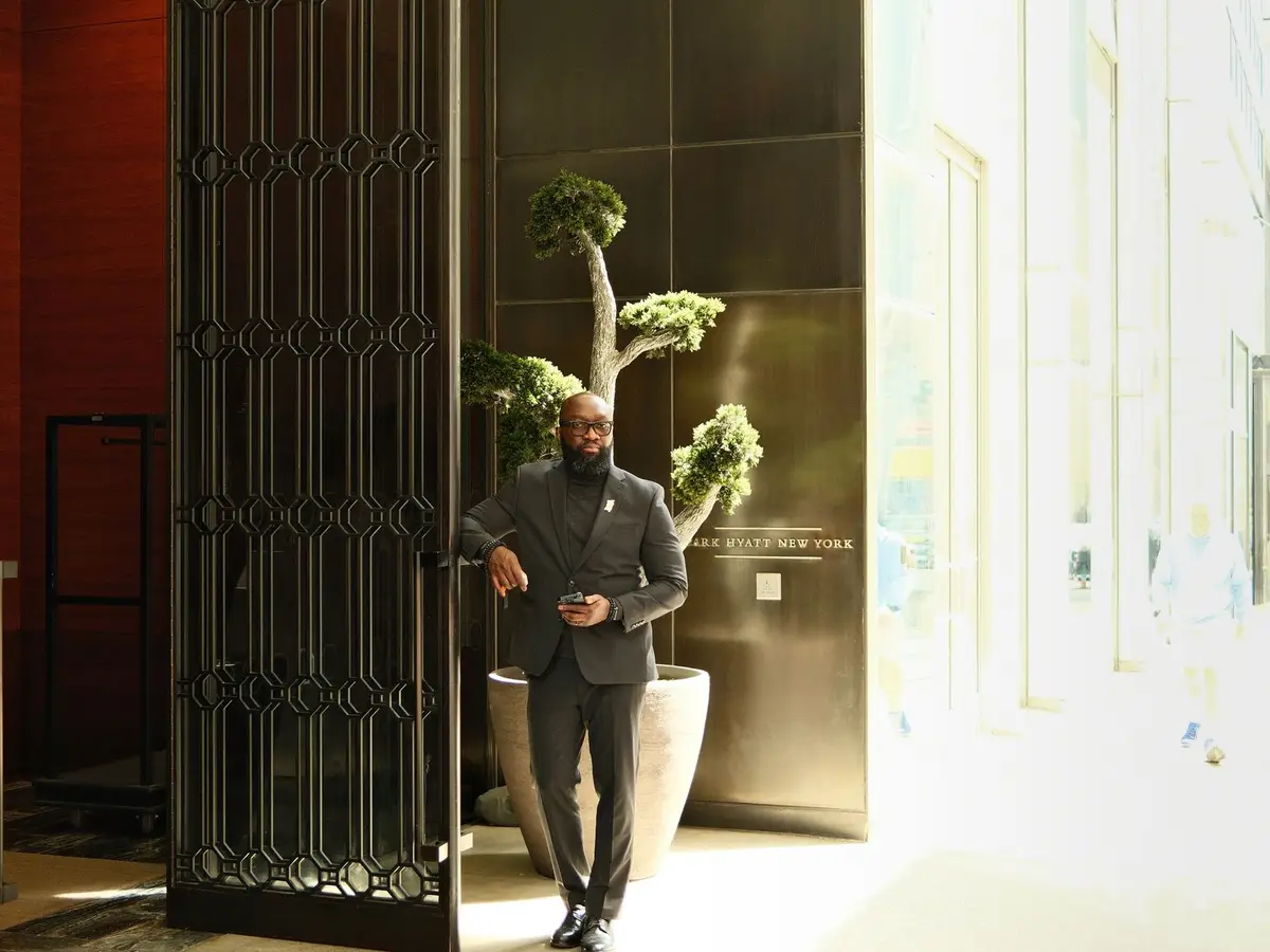 A man standing in the doorway of a residential building